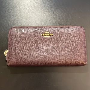 Coach. Burgundy. Zip around wallet. Excellent condition.